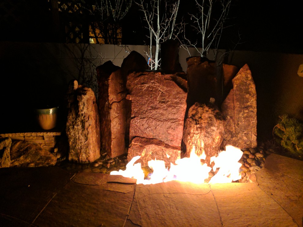 Kleiner Mediterraner Garten hinter dem Haus mit Feuerstelle und Natursteinplatten in Albuquerque