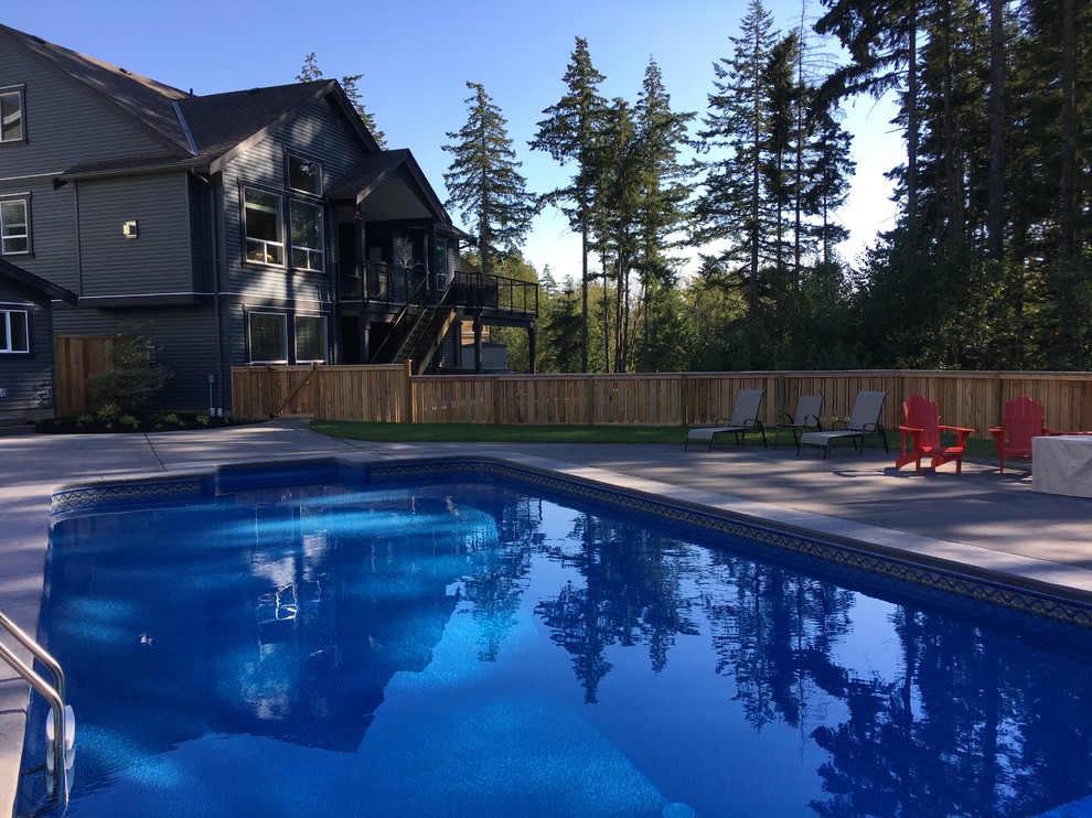 Design ideas for a medium sized rustic back private partial sun garden for summer in Vancouver with concrete paving and a wood fence.