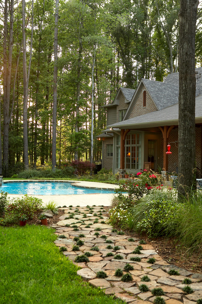 Inspiration for a traditional backyard stone landscaping in New Orleans.