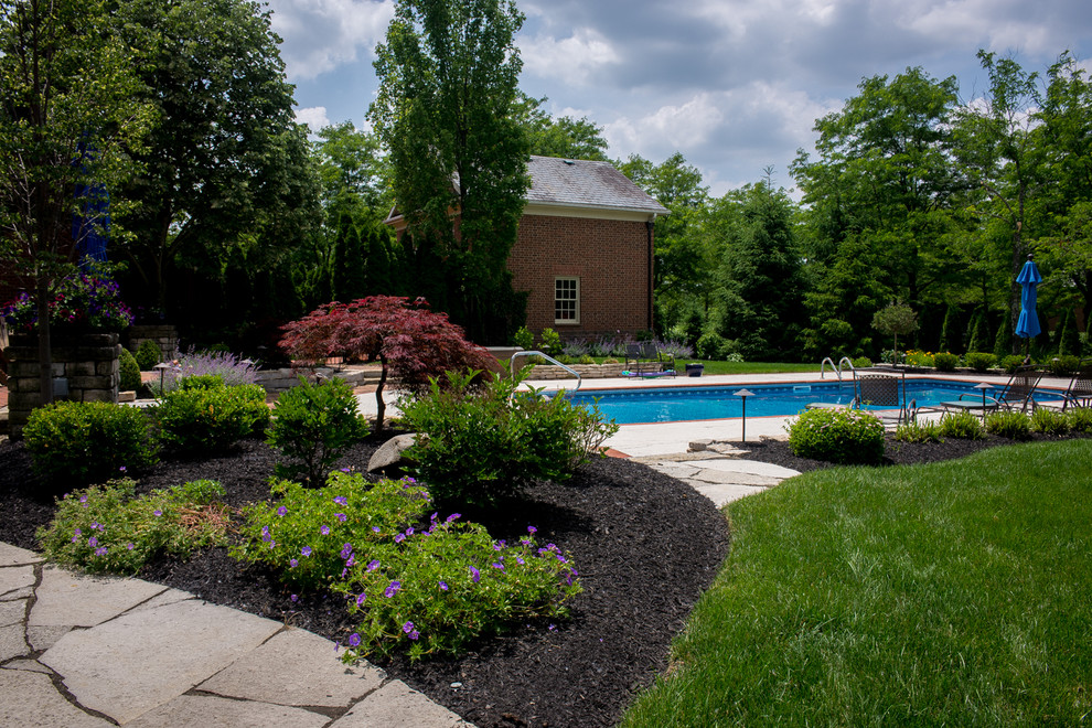 Inspiration for a large traditional back full sun garden in Columbus with a pathway and brick paving.
