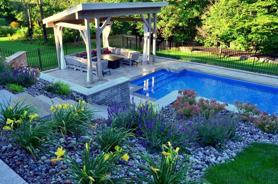 Inspiration for a large contemporary partial sun backyard concrete paver landscaping in Toronto.