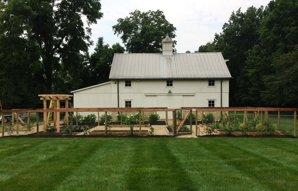 Design ideas for a transitional full sun backyard gravel vegetable garden landscape in Columbus.