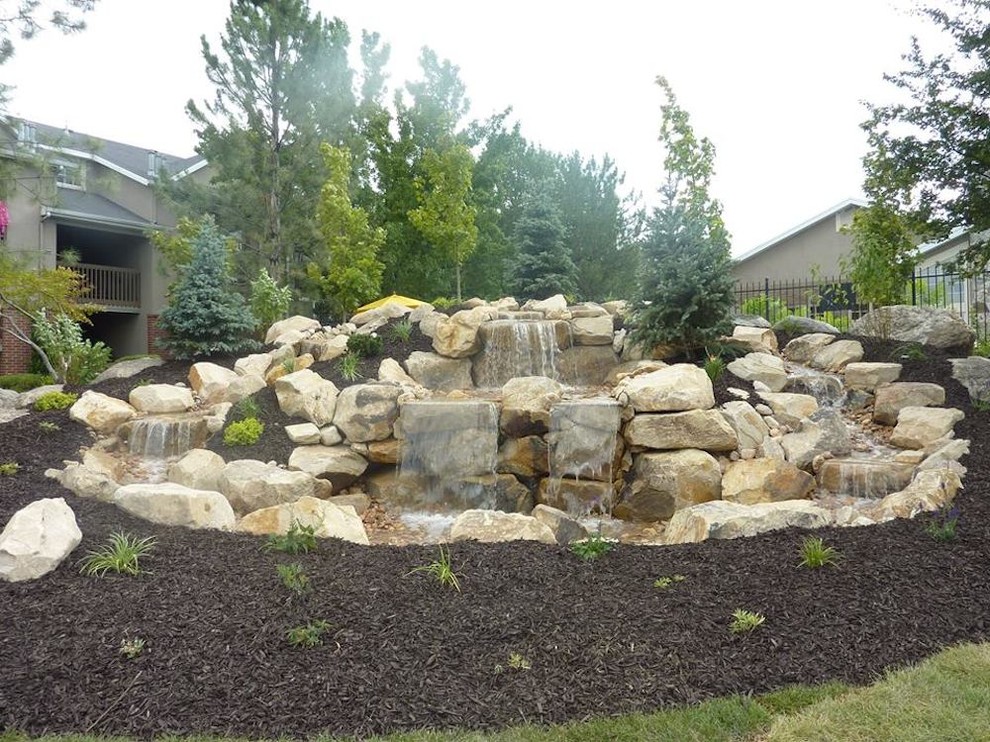 Medium sized traditional back formal garden in Salt Lake City with a water feature and natural stone paving.
