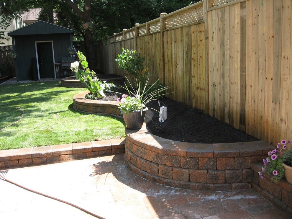 This is an example of a mid-sized contemporary shade side yard stone landscaping in Toronto for summer.