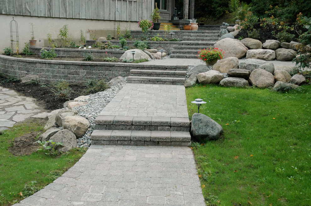 Inspiration for a large traditional partial sun hillside concrete paver landscaping in Toronto for summer.