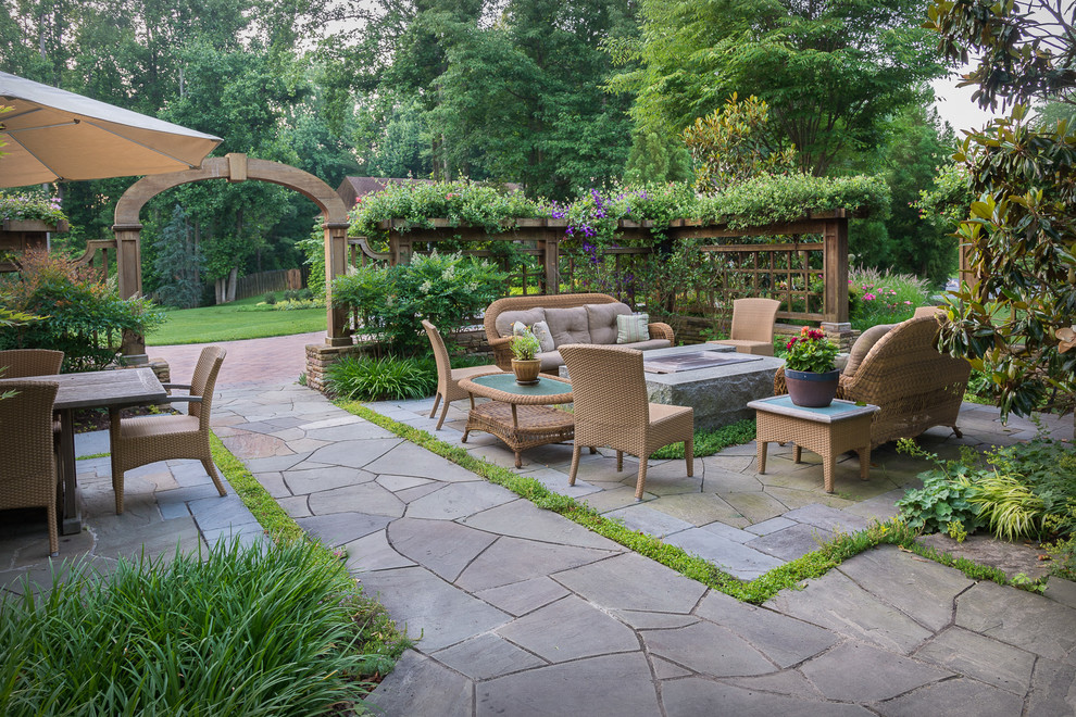 Inspiration for a huge craftsman front yard stone patio remodel in DC Metro with a fire pit
