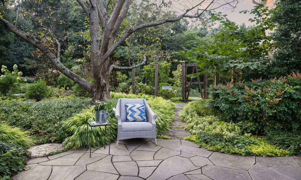 Immagine di un grande giardino formale country esposto a mezz'ombra davanti casa in estate con un focolare e pavimentazioni in pietra naturale