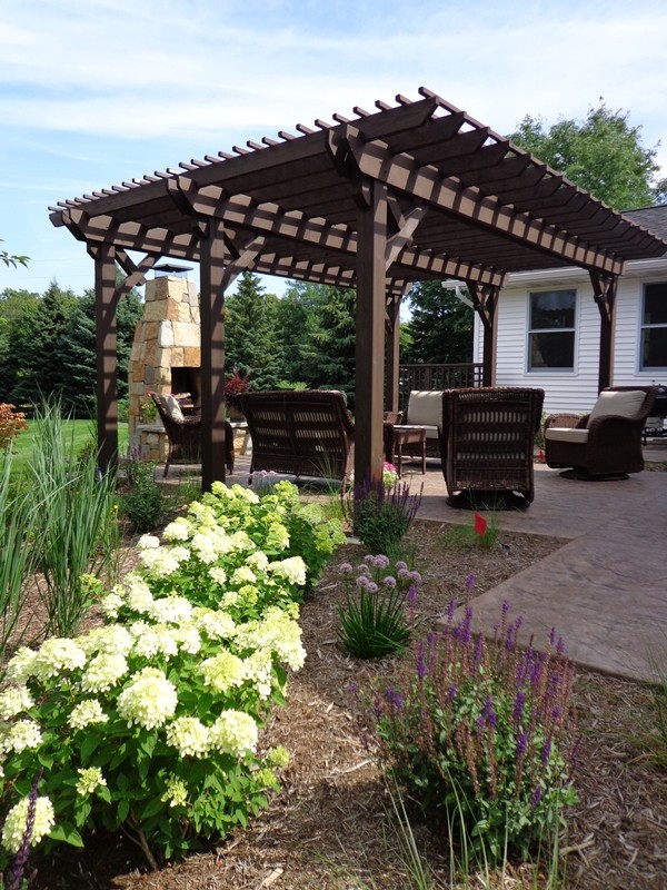 Ejemplo de jardín tradicional de tamaño medio en patio trasero con brasero y exposición total al sol