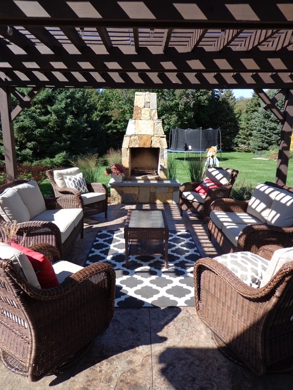 Medium sized classic back patio in Milwaukee with a fire feature.