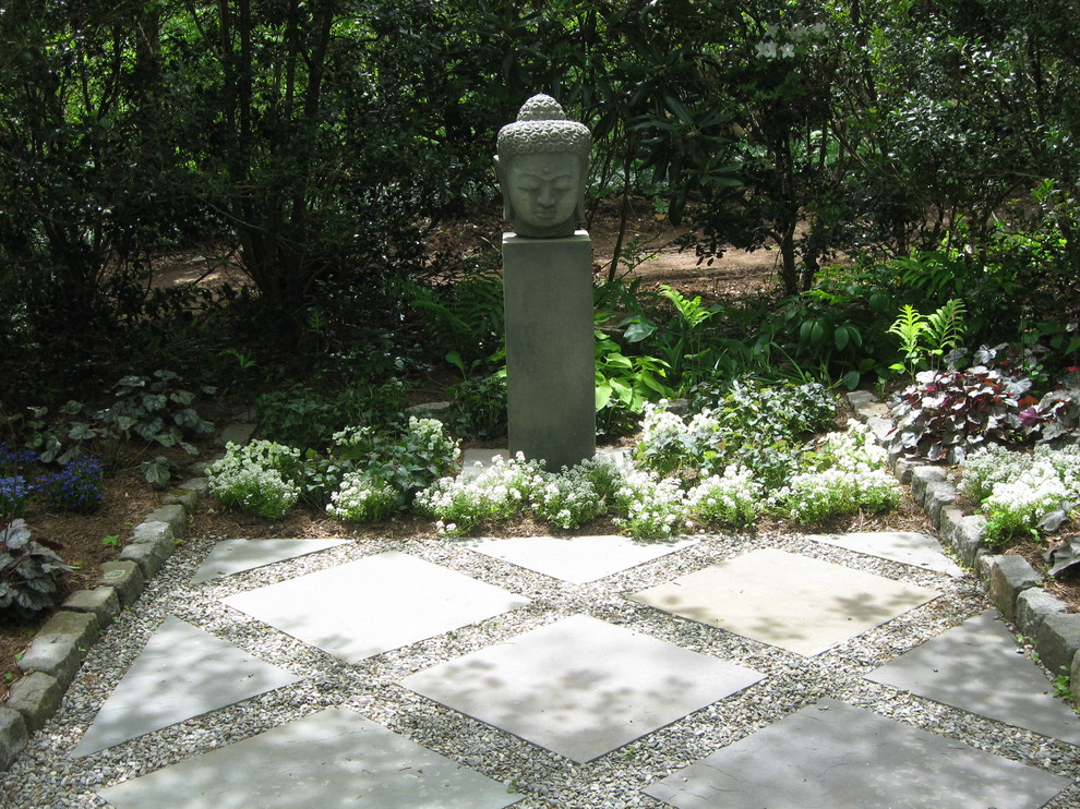 Large world-inspired courtyard formal partial sun garden for spring in Philadelphia with a garden path and concrete paving.