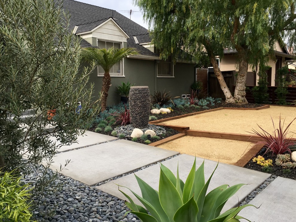 Inspiration for a mid-sized contemporary drought-tolerant and partial sun front yard concrete paver landscaping in Los Angeles.