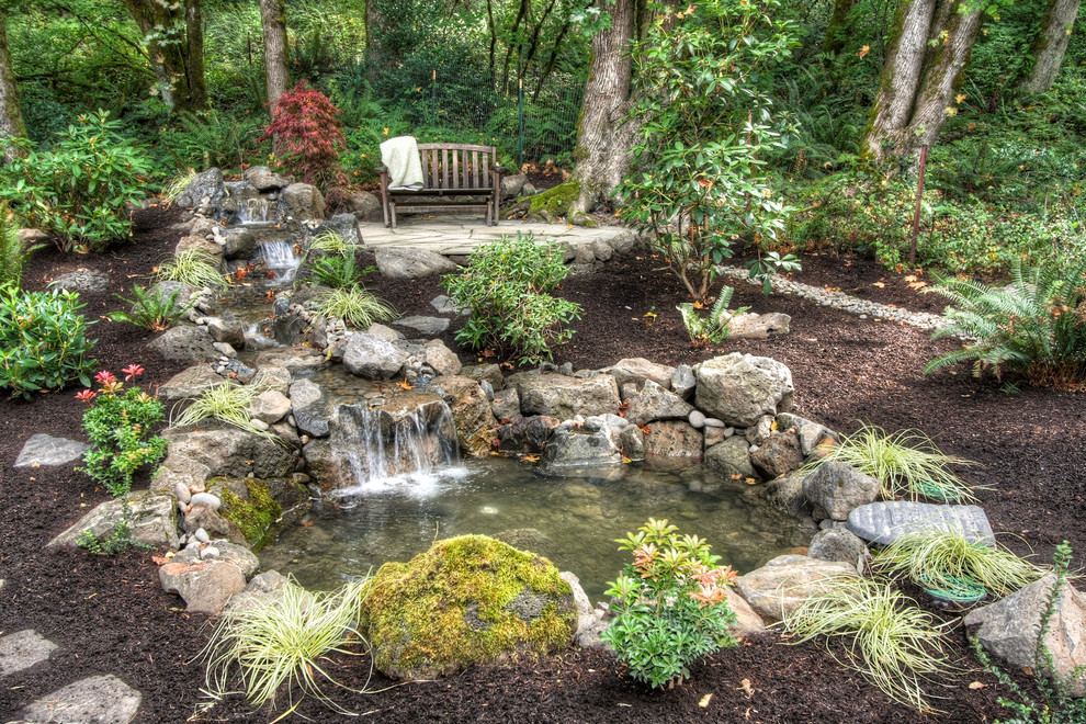 Inspiration for a rustic garden in Portland with a waterfall.