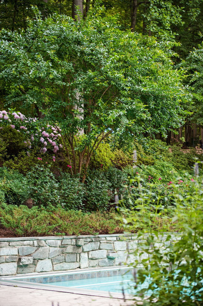 Design ideas for a huge traditional backyard retaining wall landscape in DC Metro.
