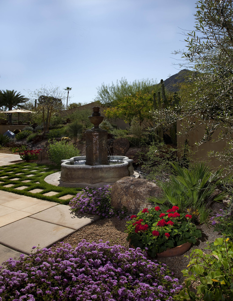 This is an example of a mediterranean garden in Phoenix with a water feature.