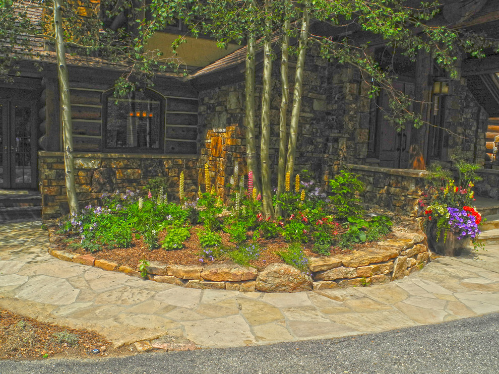 Design ideas for a classic sloped partial sun garden for summer in Denver with a retaining wall and natural stone paving.