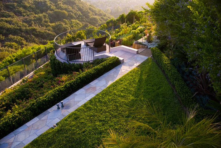 Foto di un grande giardino design dietro casa con fontane e pavimentazioni in pietra naturale