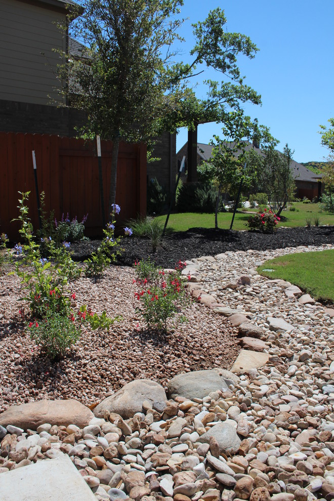Design ideas for a small contemporary drought-tolerant and partial sun front yard landscaping in Austin with decking for summer.