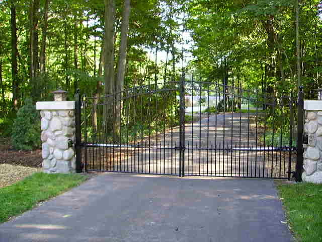 This is an example of a large traditional front driveway fully shaded garden in Grand Rapids with concrete paving.