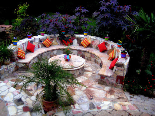 Example of an island style patio design in Raleigh