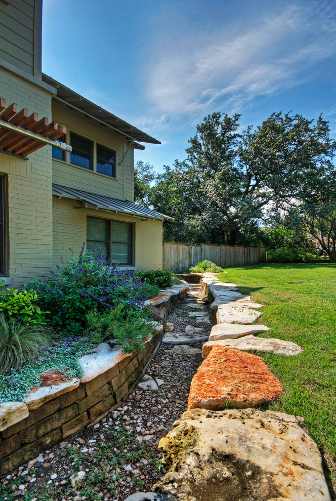 Inspiration for a large contemporary full sun front yard stone formal garden in Austin.