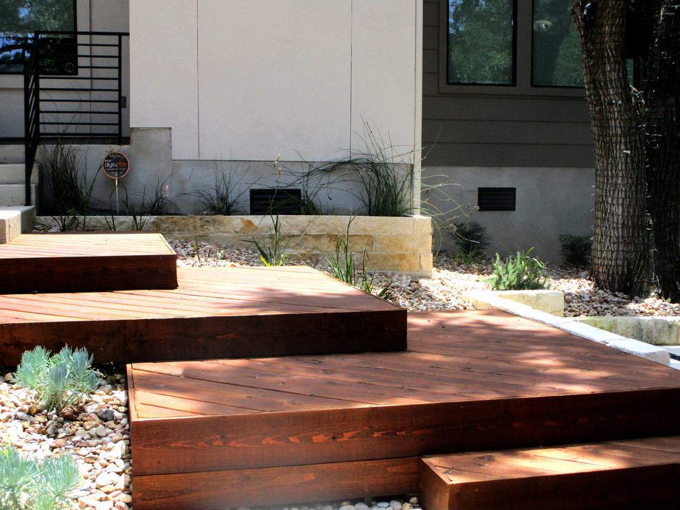 Photo of a small contemporary drought-tolerant and partial sun backyard landscaping in Austin with decking for summer.