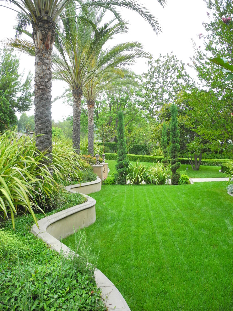 This is an example of a medium sized world-inspired front full sun garden in Orange County.
