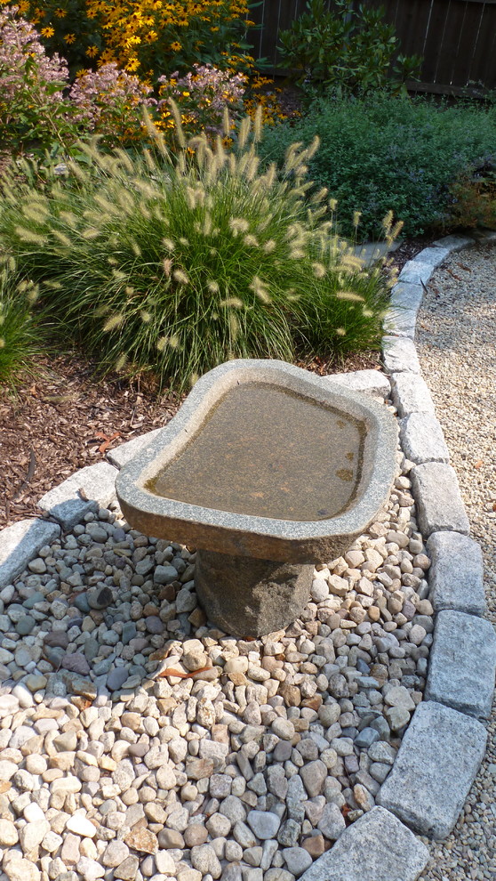 This is an example of a large mediterranean back formal partial sun garden in Providence with a garden path and gravel.