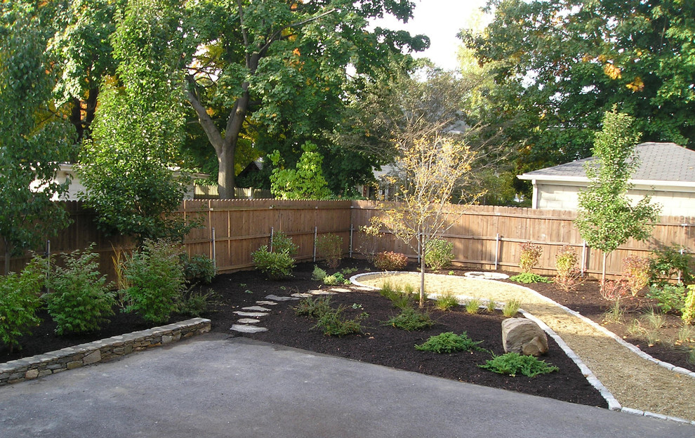 Inspiration for a large mediterranean partial sun backyard gravel landscaping in Providence.