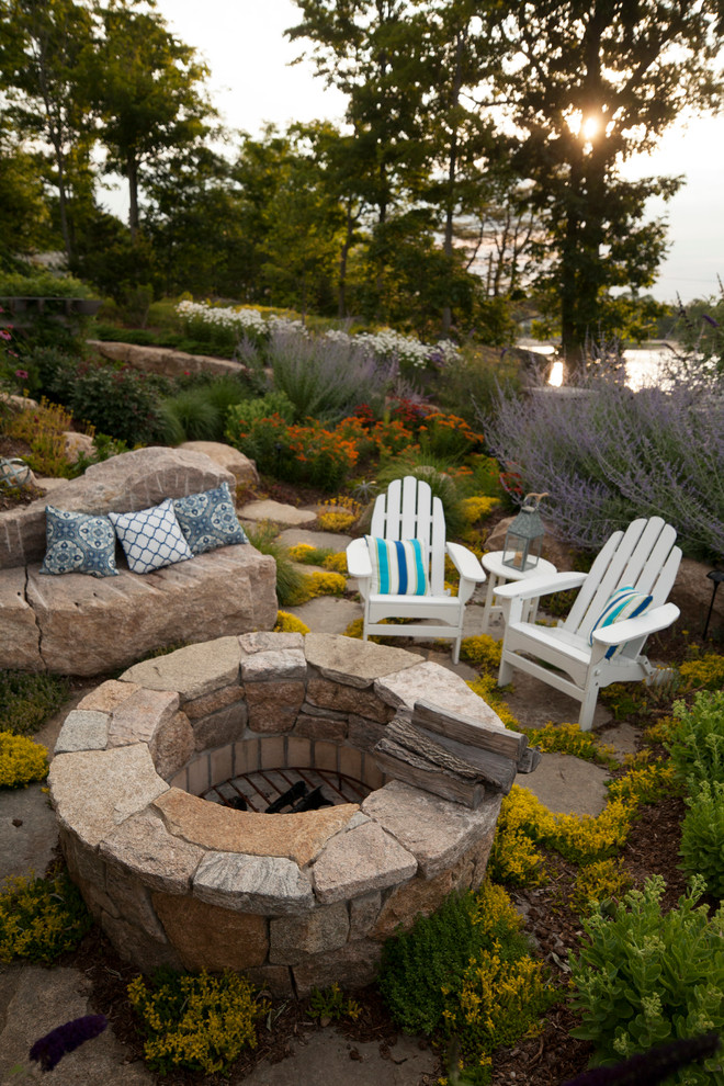 Klassischer Garten im Sommer, hinter dem Haus mit Feuerstelle, direkter Sonneneinstrahlung und Natursteinplatten in Bridgeport