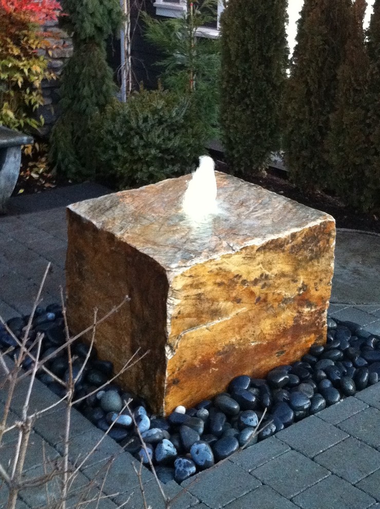 Inspiration for a small modern partial sun front yard brick water fountain landscape in Vancouver for spring.