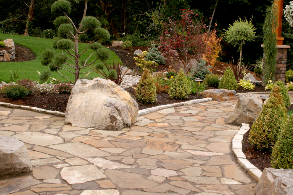 This is an example of a traditional backyard stone landscaping in Portland.