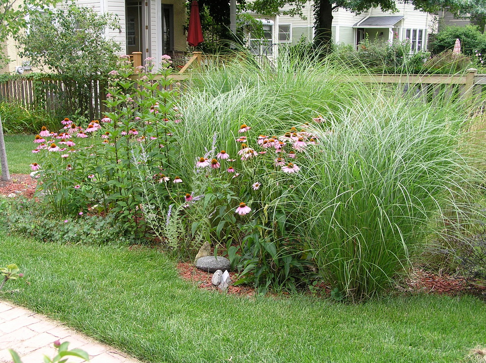 Inspiration for a contemporary partial sun backyard brick landscaping in Chicago.