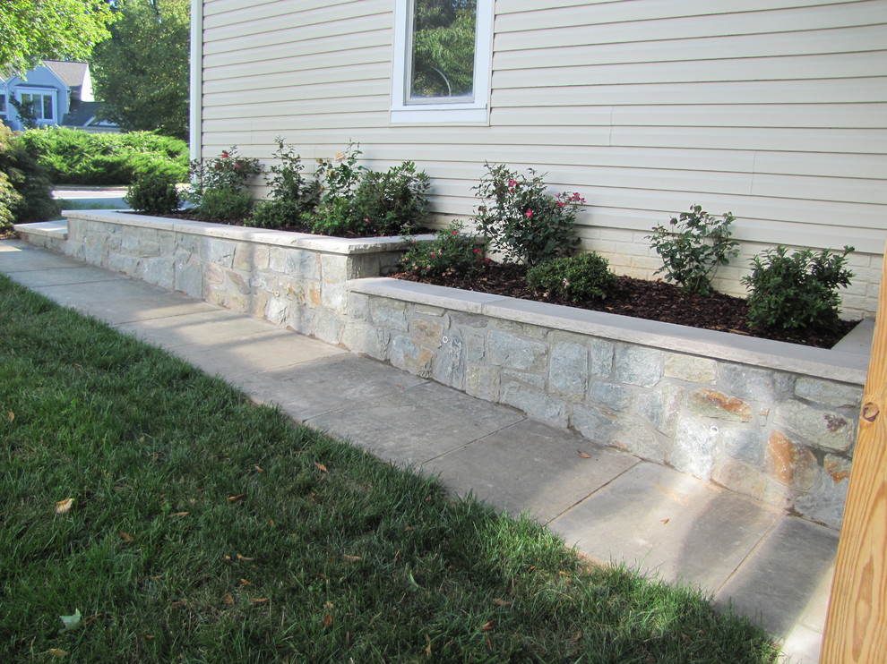 Design ideas for a mid-sized traditional partial sun backyard stone landscaping in DC Metro.