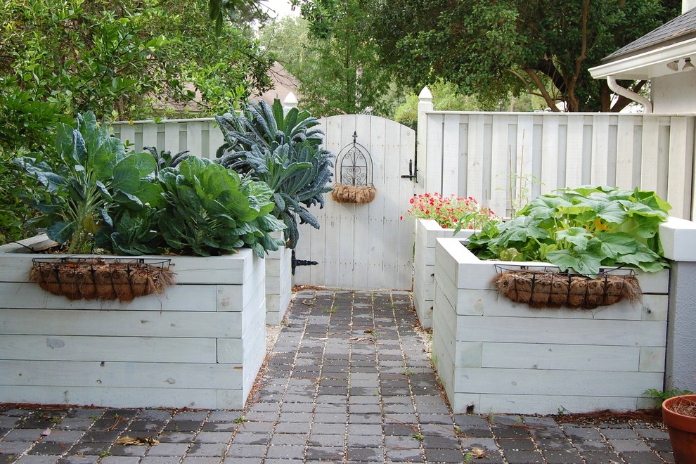 This is an example of a mid-sized rustic partial sun backyard concrete paver vegetable garden landscape in Jacksonville.