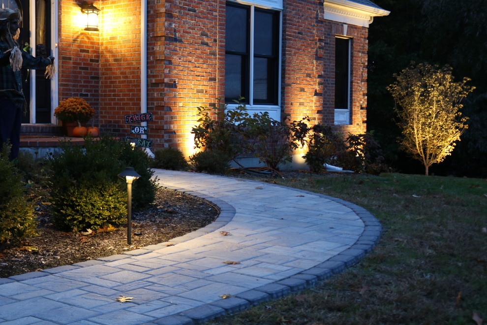 This is an example of a contemporary full sun front yard concrete paver landscaping in Boston.
