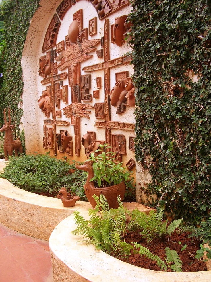 World-inspired back garden in Bengaluru with a living wall.