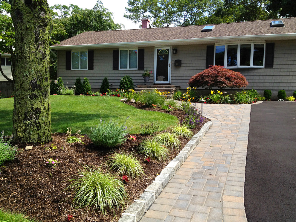 Design ideas for a contemporary front yard concrete paver driveway in New York.