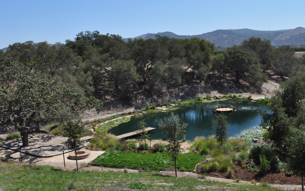 Photo of a mid-sized mediterranean full sun backyard pond in Santa Barbara.