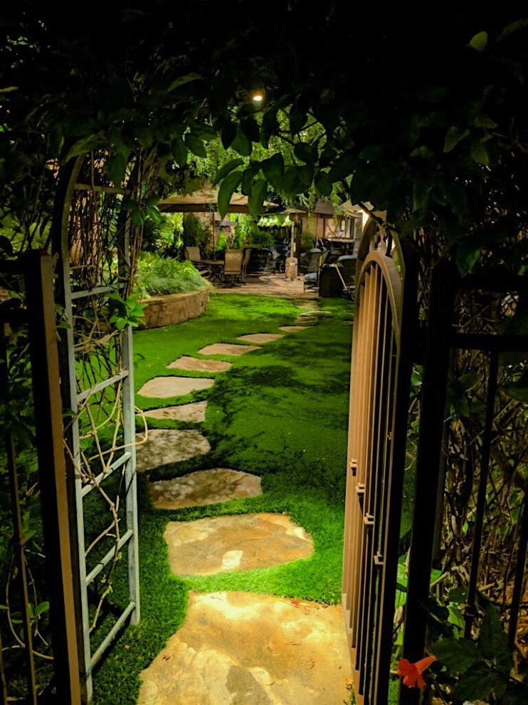 This is an example of a large contemporary backyard formal garden in Los Angeles.