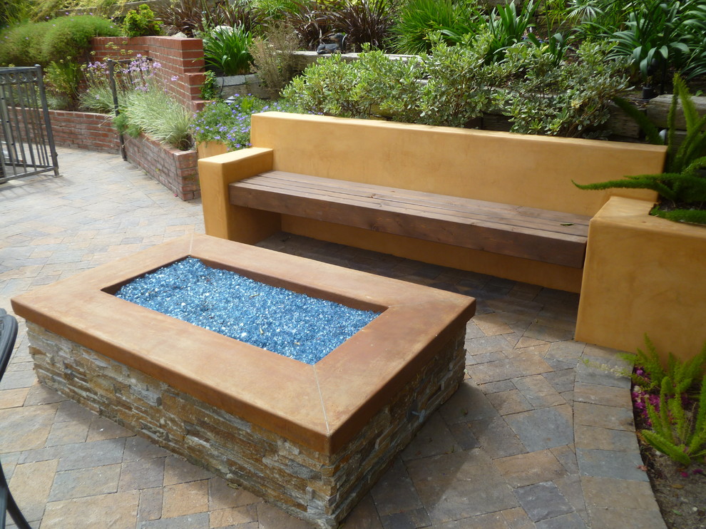 Inspiration for a medium sized mediterranean back full sun garden in Los Angeles with a fire feature and concrete paving.
