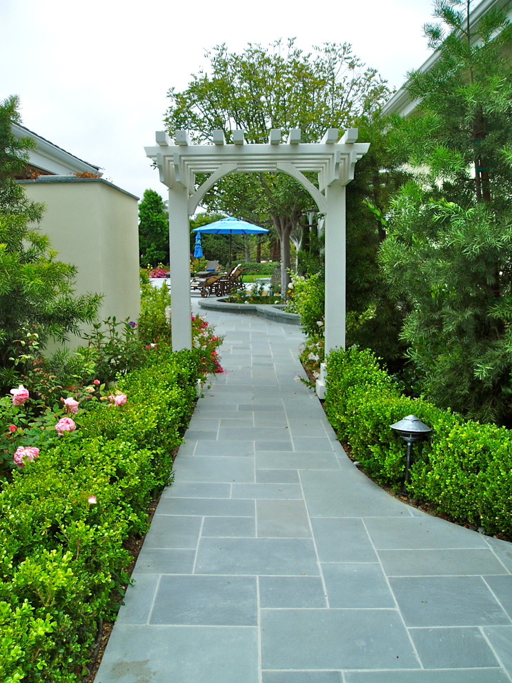Photo of a traditional courtyard full sun garden in San Diego with natural stone paving.