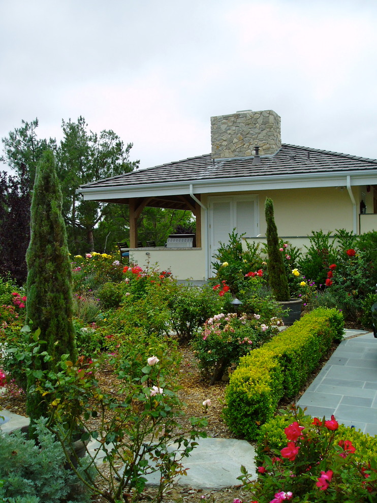 This is an example of a traditional full sun garden in San Diego with a garden path and mulch.