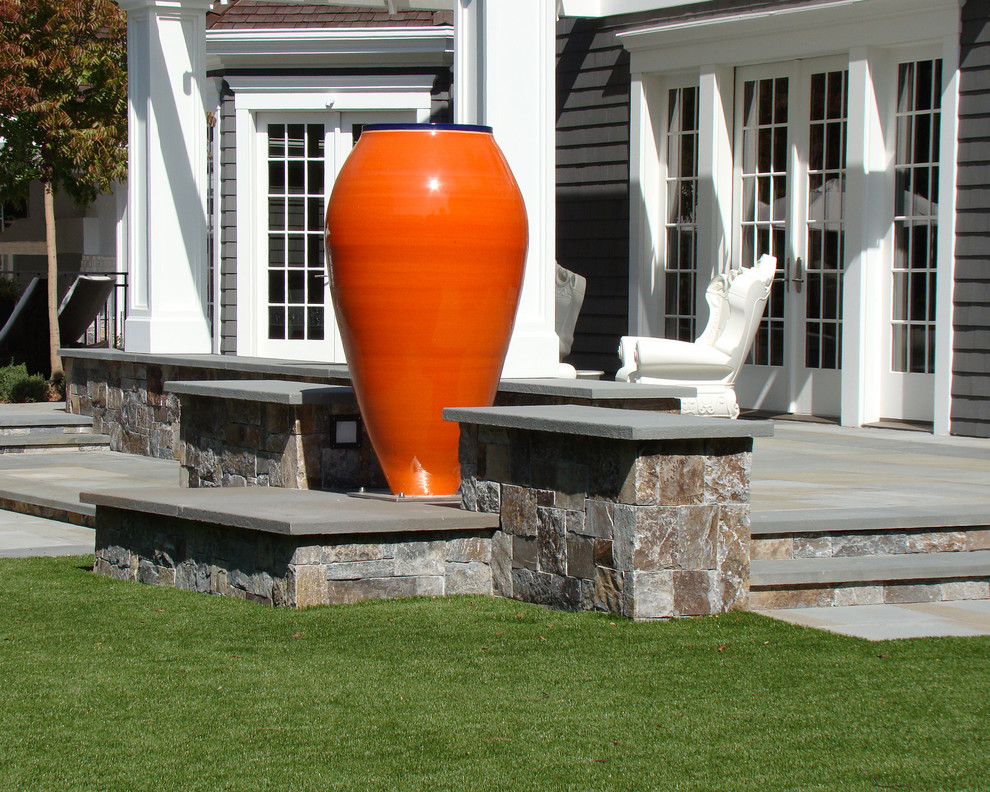 Ejemplo de jardín clásico en patio trasero con adoquines de piedra natural