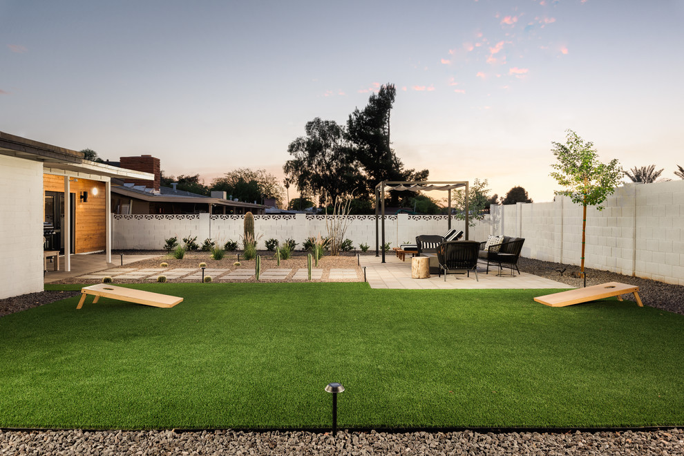 Inspiration for a medium sized modern back garden in Phoenix with a fire feature and concrete paving.