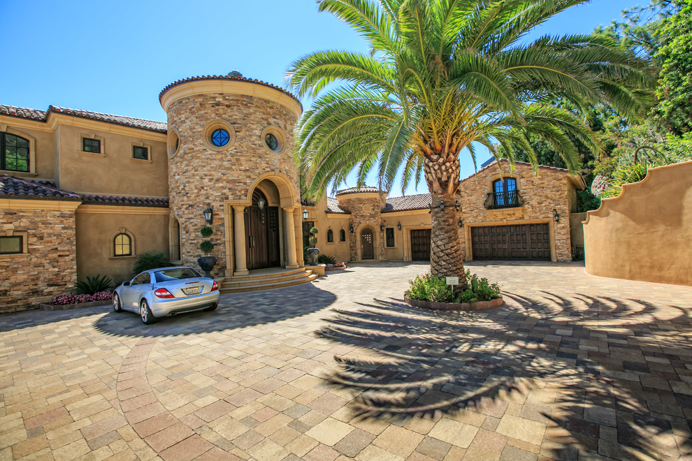 This is an example of a huge mediterranean front yard concrete paver driveway in San Diego.