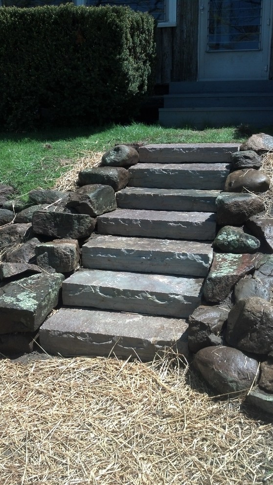 This is an example of a traditional courtyard stone retaining wall landscape in Detroit for summer.