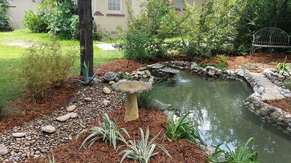 Design ideas for a mid-sized traditional partial sun backyard stone landscaping in Atlanta for spring.