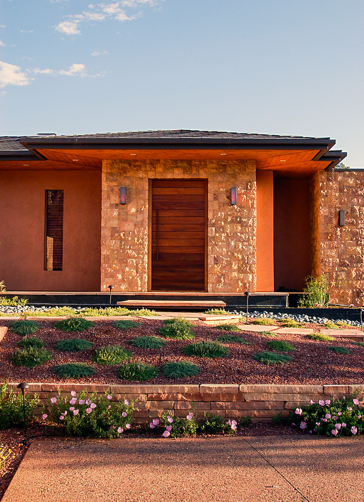 Inspiration for a large contemporary drought-tolerant and full sun front yard gravel landscaping in Phoenix for summer.