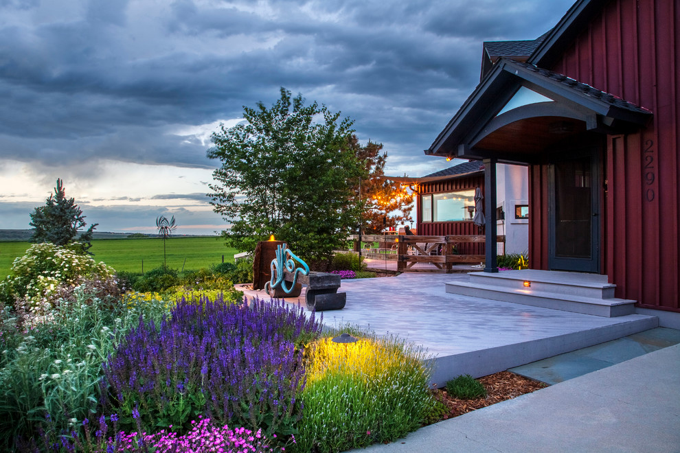 This is an example of a mid-sized contemporary full sun front yard landscaping in Denver with decking.