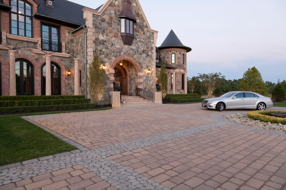 Photo of an expansive traditional driveway garden in Philadelphia with concrete paving.